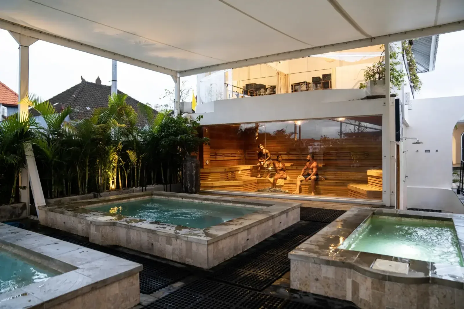 Three people in the sauna beside the plunge pools in the recovery area at Body Factory Canggu